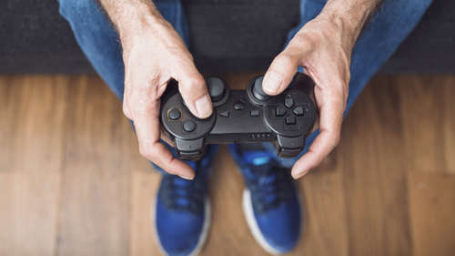 close-up-senior-man-s-hand-holding-video-game-console_23-2147935596.jpg